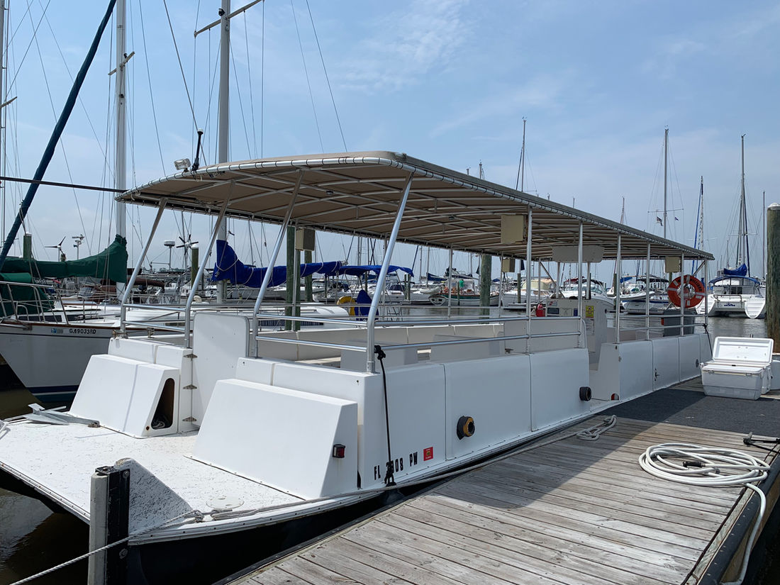 The Lighthouse Dolphin Tours boat at the dock at Morningstar Marinas
